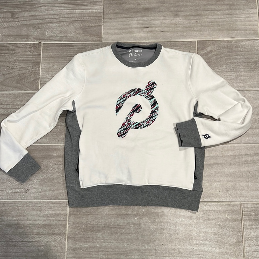 Peloton sweatshirt, gray, and white with zipper pockets in front